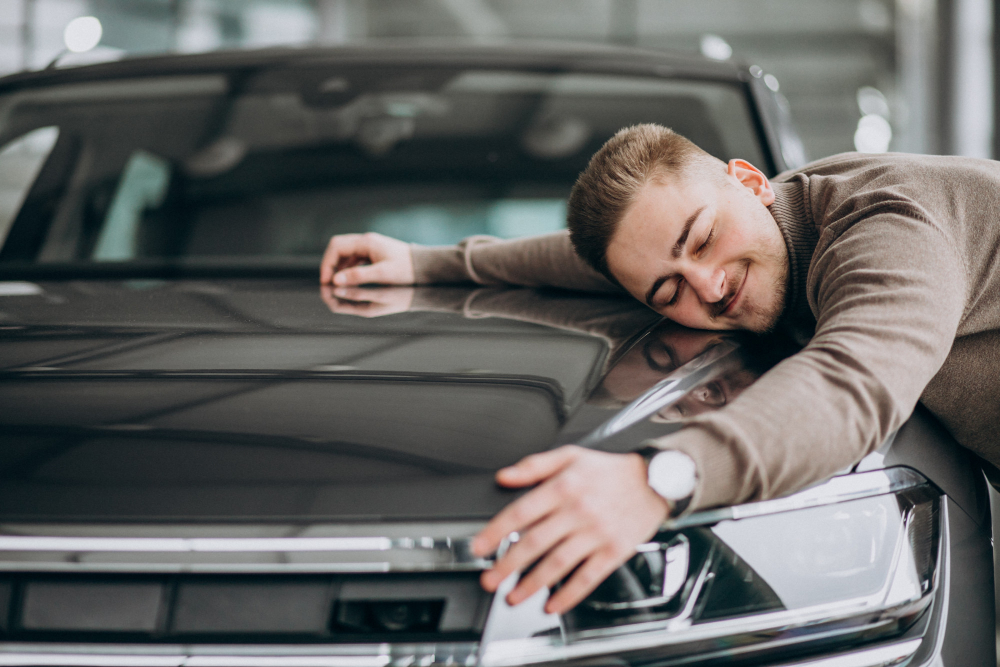 young-handsome-man-hugging-car-car-showroom